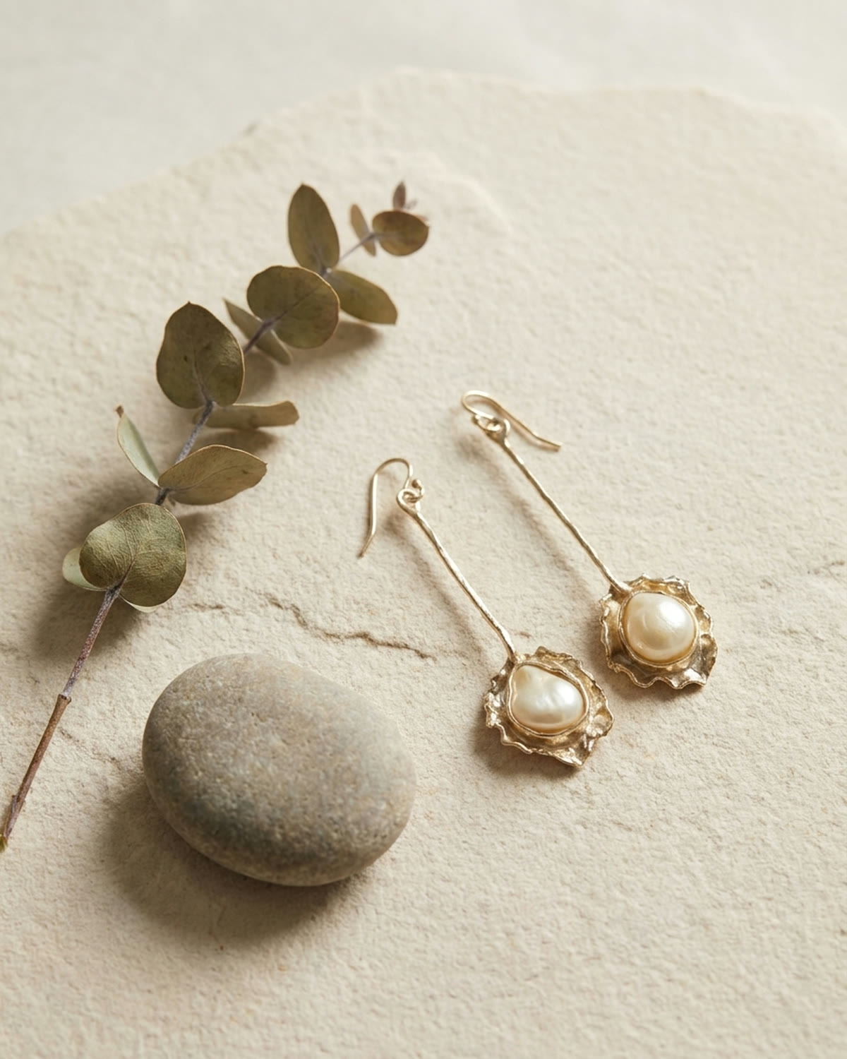 Pearl earrings in a botanical still life arrangement